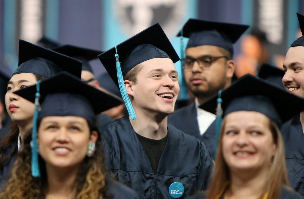 Happy grad in coliseum.