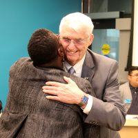 Harper hugs Justice Nelson.