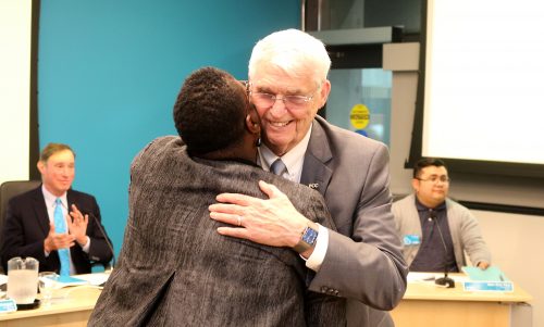 Harper hugs Justice Nelson.