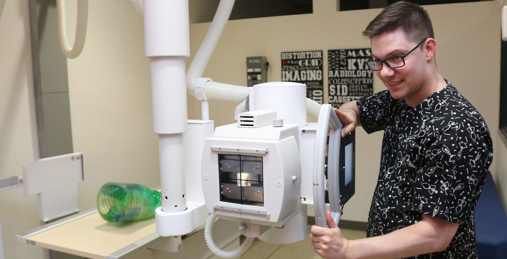 Jonah Scott using an x-ray machine.