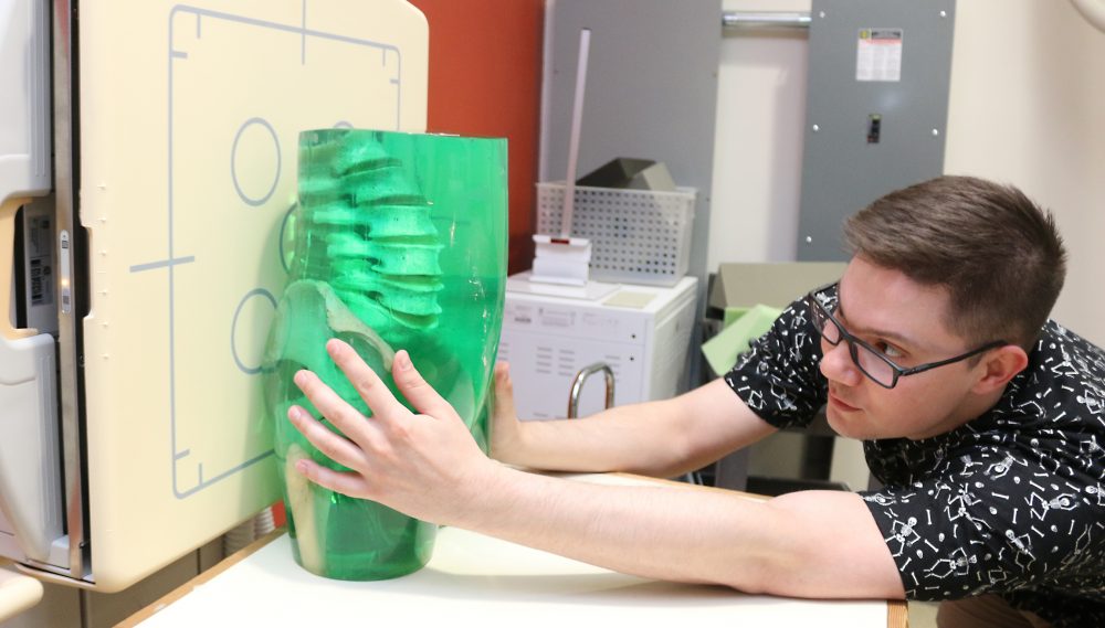 Jonah Scott positions rubber torso for an x-ray.