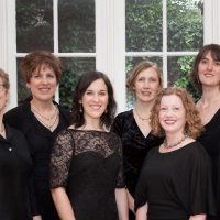 six women in black dresses