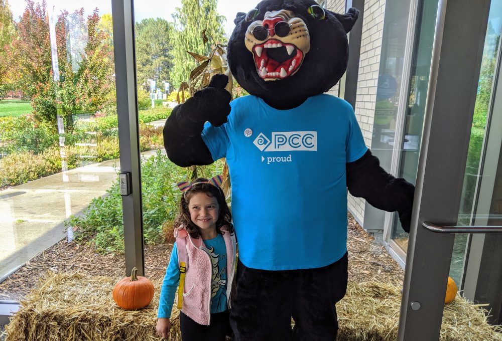 little girl with Poppie the Panther mascot