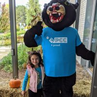 little girl with Poppie the Panther mascot