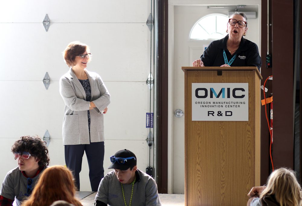 Betsy Johnson speaks while Suzanne Bonamici and the students listen.