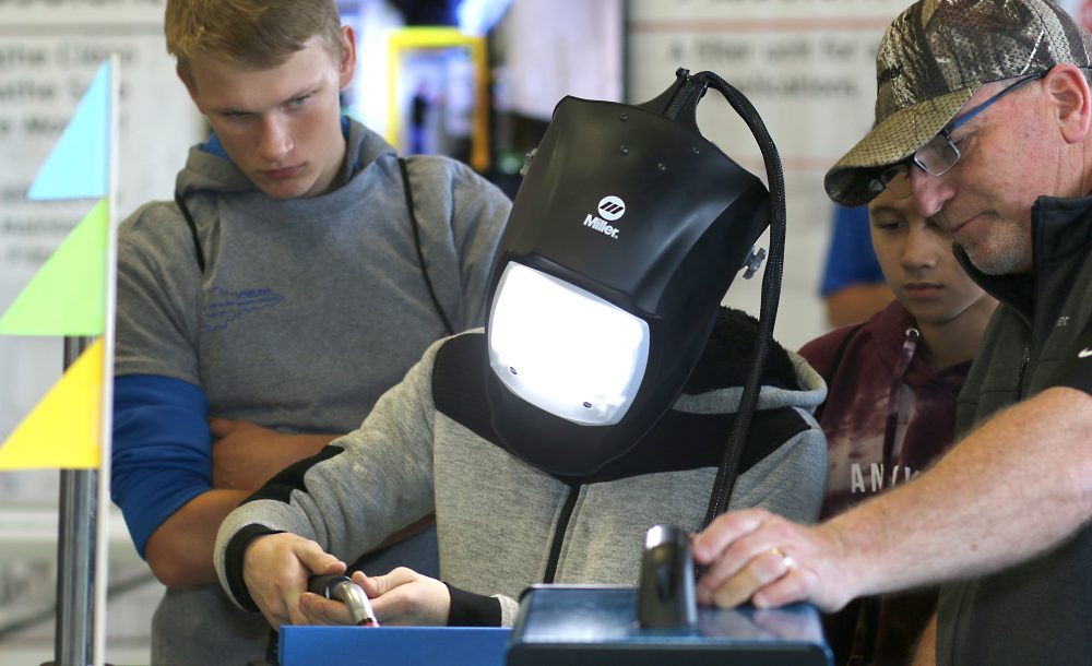 Kid in virtual welding gear.