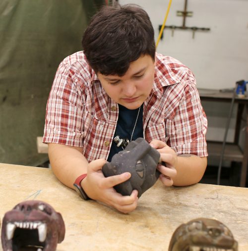 Hal Shaw inspects a panther head.