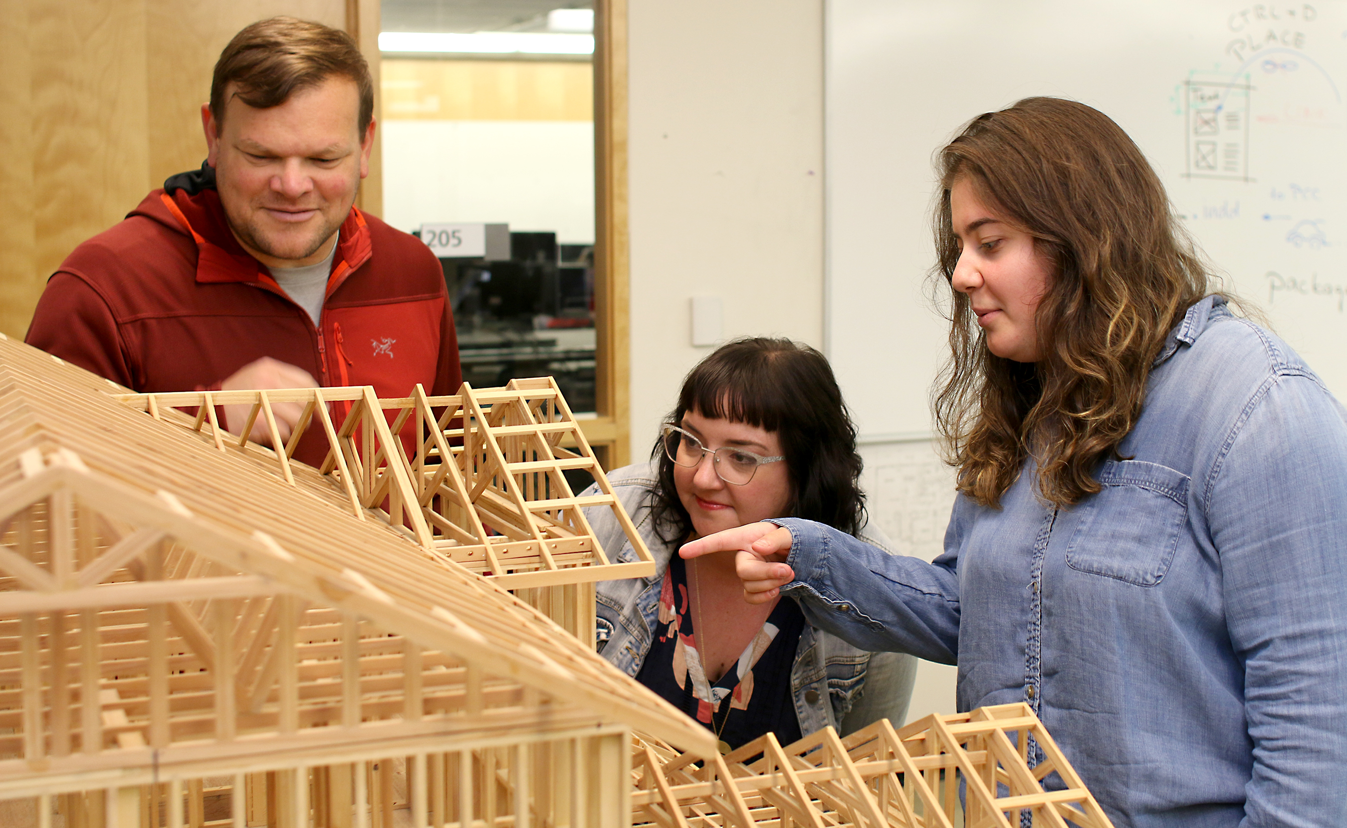 Student Braa Aldebi works on a problem with her classmates.