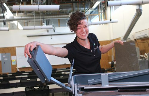 Leslie Smith cutting metal for HVAC vents.