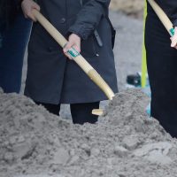 Groundbreakers digging with shovels