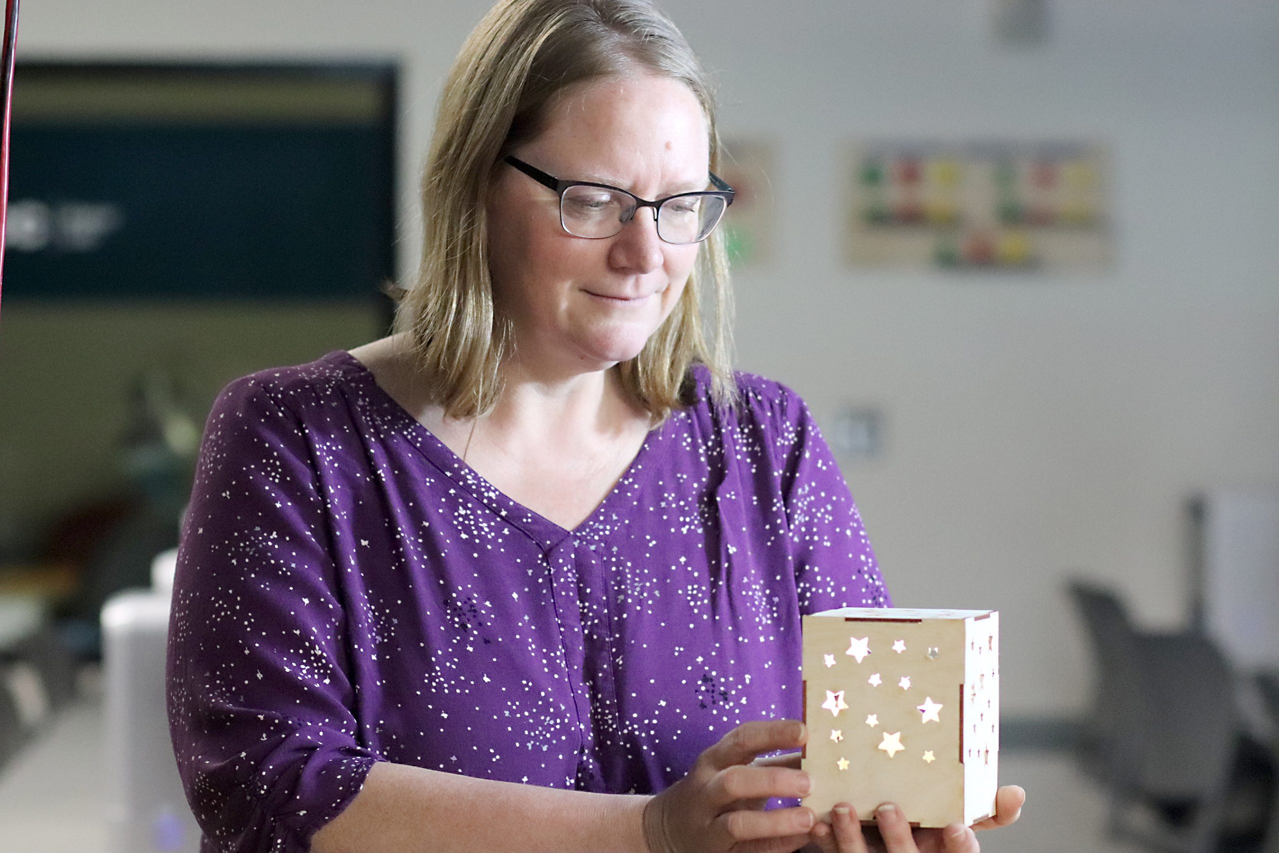 Amy Petit holds laser-cut lantern.