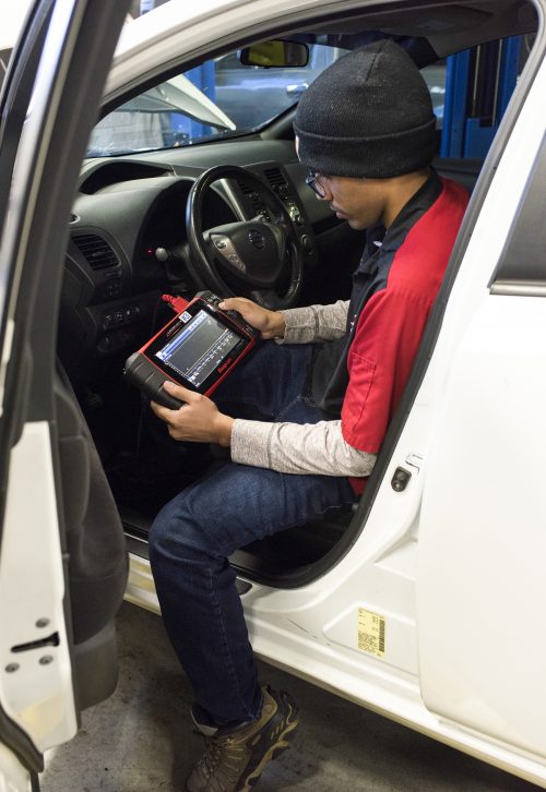 Luna performs a diagnostics test on one of PCC's shop vehicles.