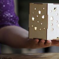 Amy Petit holds laser-cut lantern.