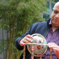 Ali looking at a globe