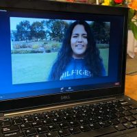 woman smiling on computer screen
