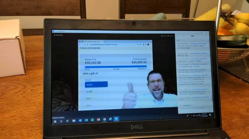 man giving thumbs up on computer screen