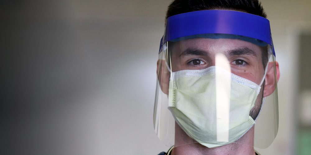 Student wearing a mask and face shield