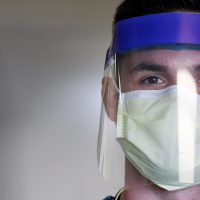 Student wearing a mask and face shield
