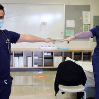 Students show how to socially distance.