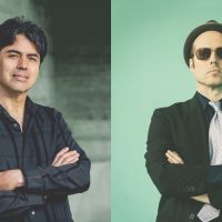 two men with arms folded