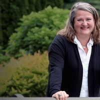 Sarah Mooney standing outside and smiling at the camera