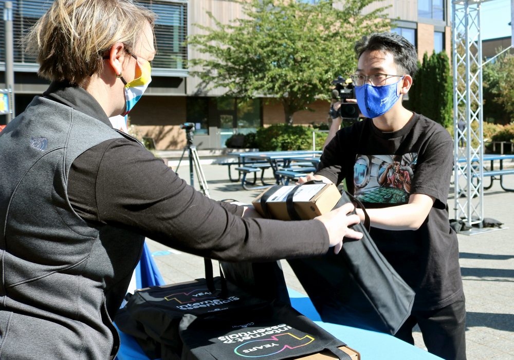 Tin Lee receives his Dell Chromebook from Comcast VP of External Affairs Marion Haynes.