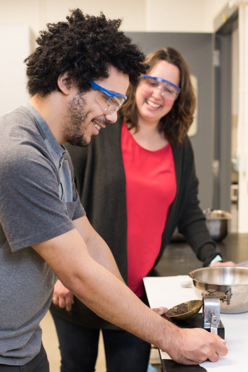 Instructor Tara Nelson supervises student Zachary McKay during a civil and mechanical engineering materials testing lab.