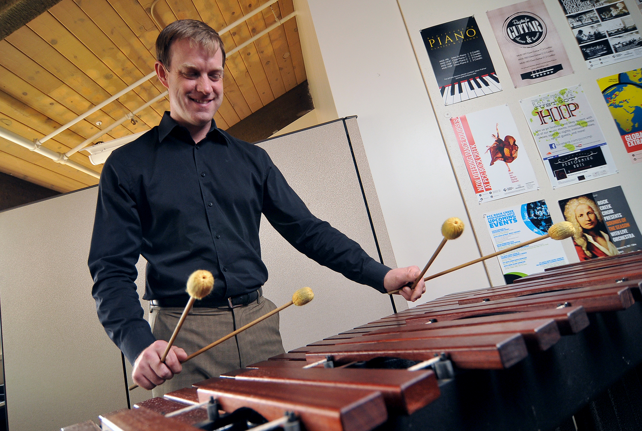 Music instructor playing instrument.