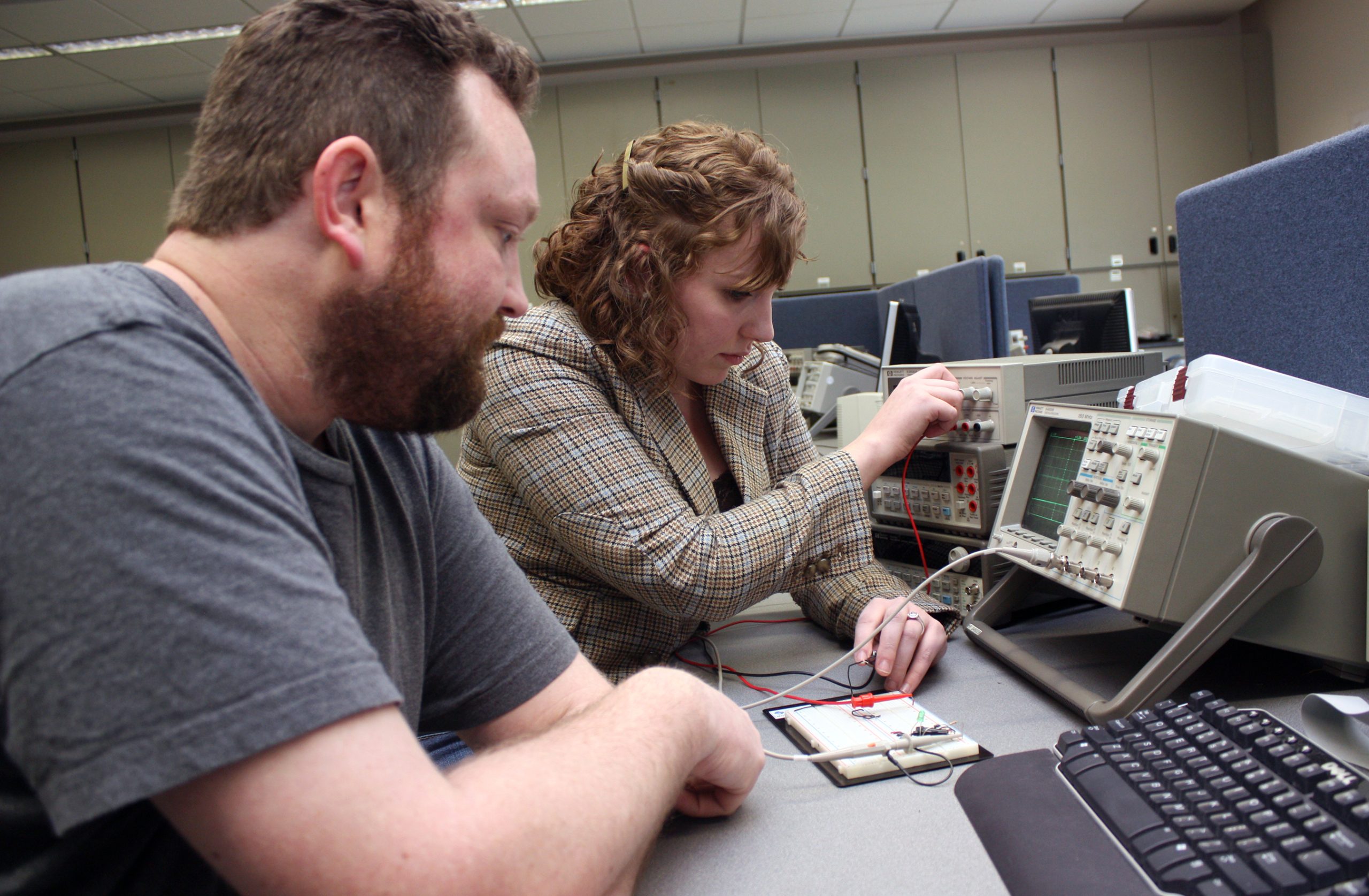 Students working on microelectronics equipment.