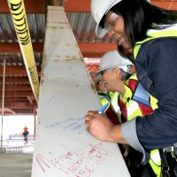 Staff and faculty sign first construction beam at Rock Creek's Building 5.
