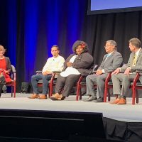 Mark Mitsui discusses education with the panelists at the 19th Annual Oregon Leadership Summit of the Oregon Business Plan.