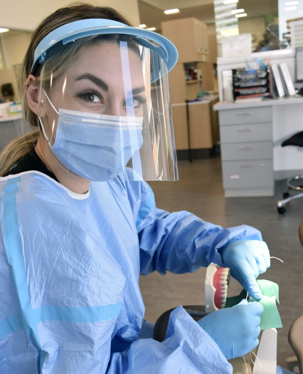 Student practicing teeth cleaning.