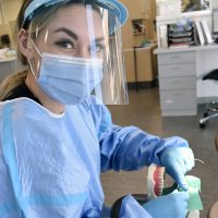 Student practicing teeth cleaning.