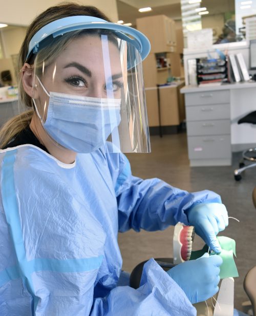 Student practicing teeth cleaning.
