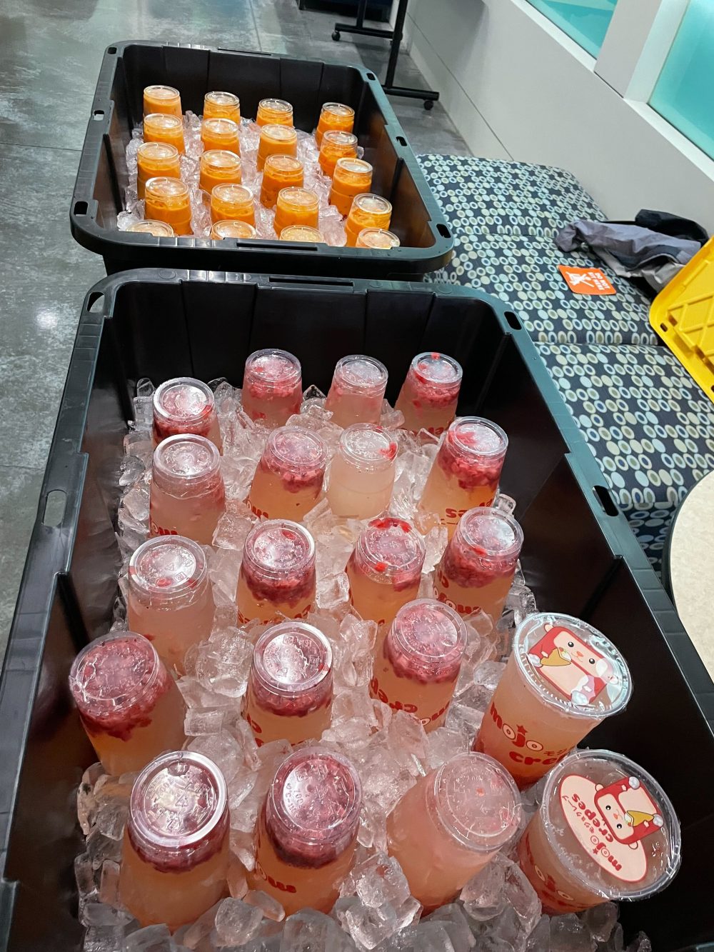 Table with buckets filled with ice and beverages.