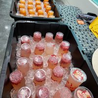 Table with buckets filled with ice and beverages.