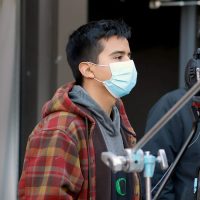 Video Production student in the studio with a camera