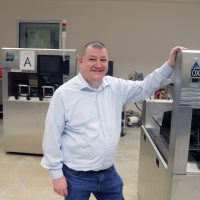 Steven Duggan posing in the microelectronics lab at PCC.
