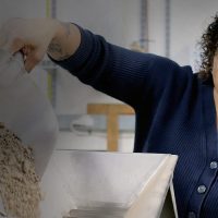 Ellissa Stevenson pouring soil.