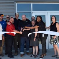 From left, Michael Sonnleitner (PCC board), Sander Torgeson (faculty), Mace Gjerman (Caterpillar), Bobby Vellum (ThinkBIG program manager), Dan Brotherton (PCC alum), Jesse Norconk (ThinkBIG faculty chair), Kevin Comstock (faculty), Karen Sanders (dean), PCC President Dr. Adrien Bennings, Kristi Wilson (PCC board) and Laurie Cremona Wagner (PCC board vice chair).