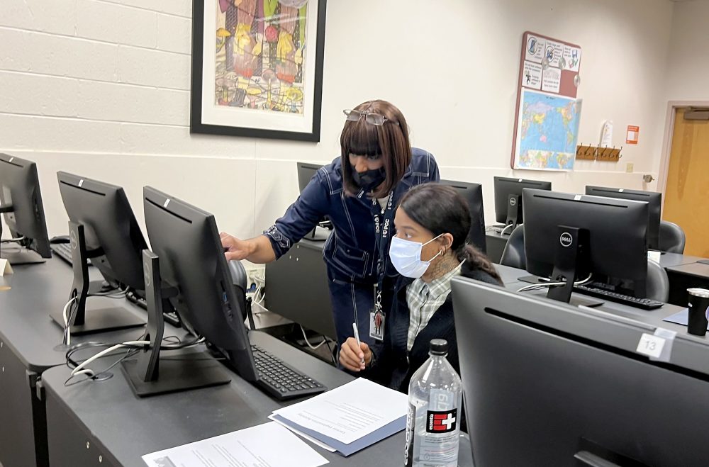 Tracee helps a student