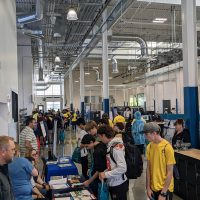 students visiting with industry representatives inside manufacturing training center