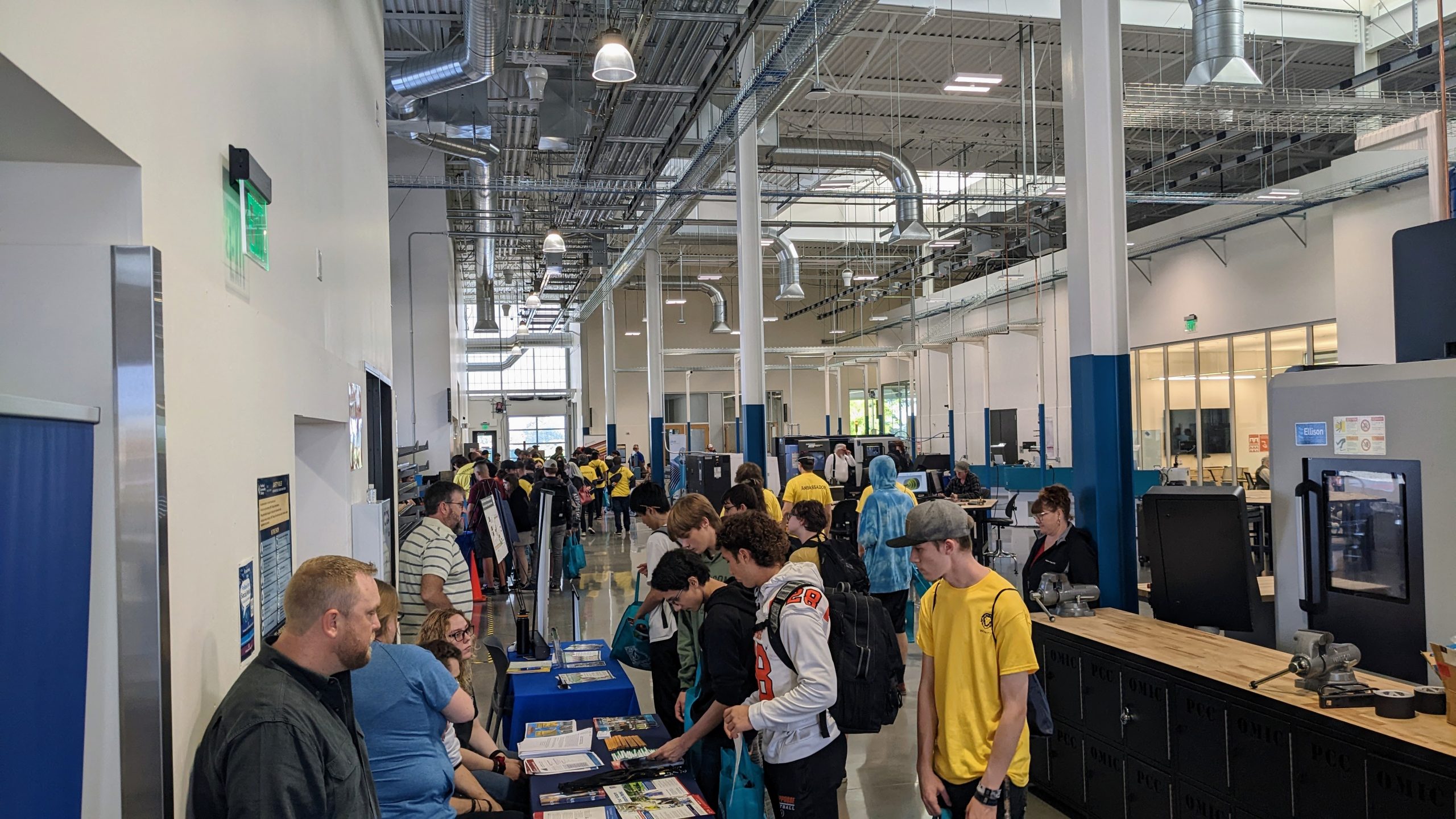 students visiting with industry representatives inside manufacturing training center