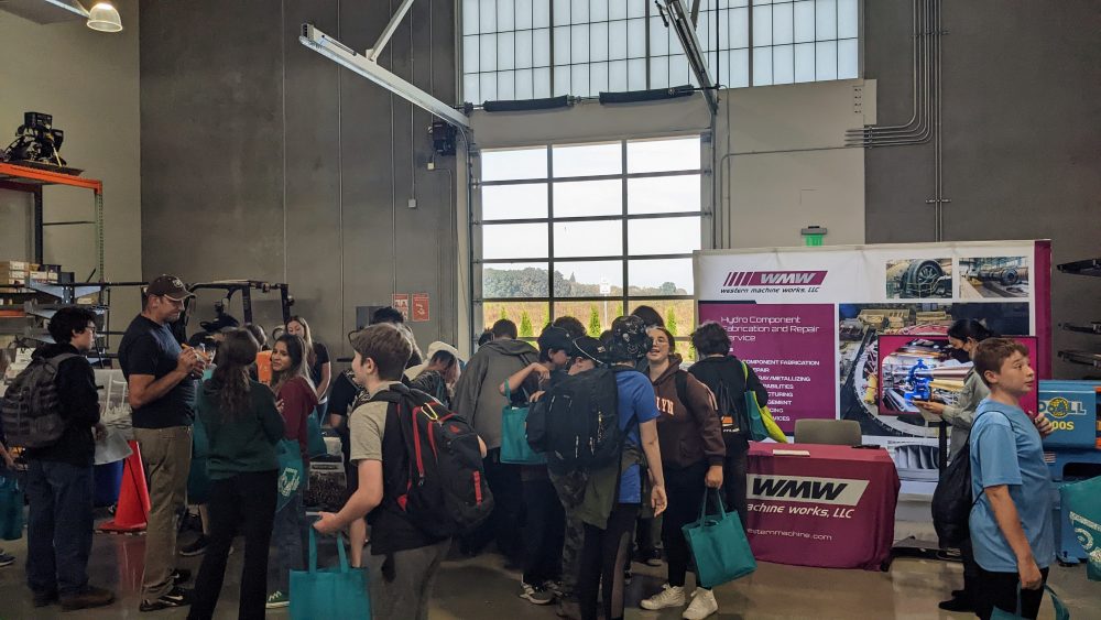 students visiting with industry representatives inside manufacturing training center