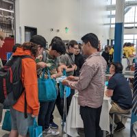 students visiting with industry representatives inside manufacturing training center