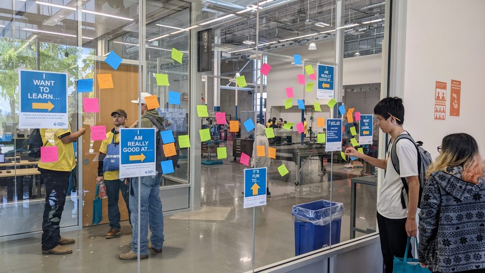 glass wall with brainstorm post-it notes attached