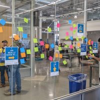 glass wall with brainstorm post-it notes attached