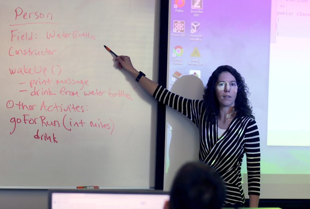 Cara Tang pointing at board