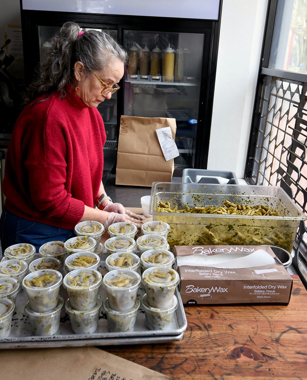 Deborah Mustard at work in deli.
