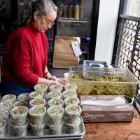 Deborah Mustard at work in deli.